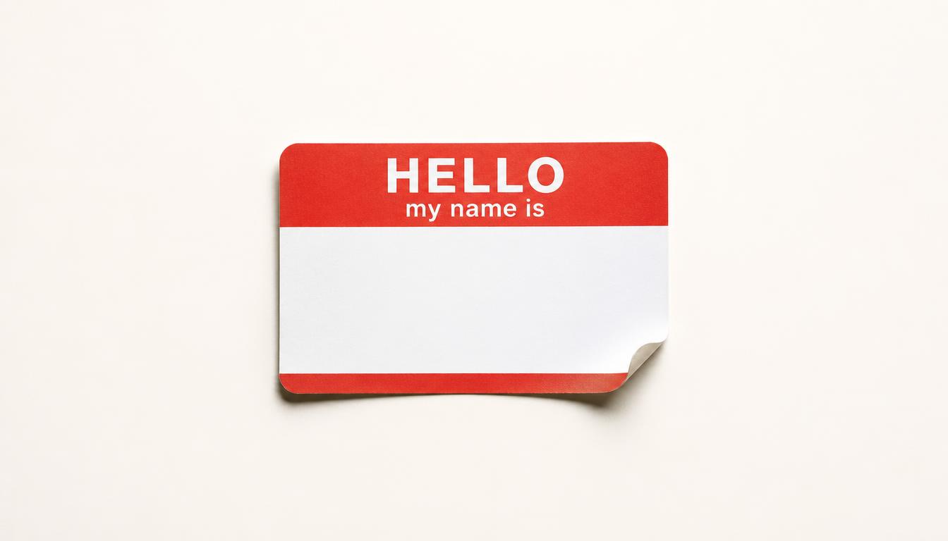 A blank HELLO my-name-is sticker badge on a cream background